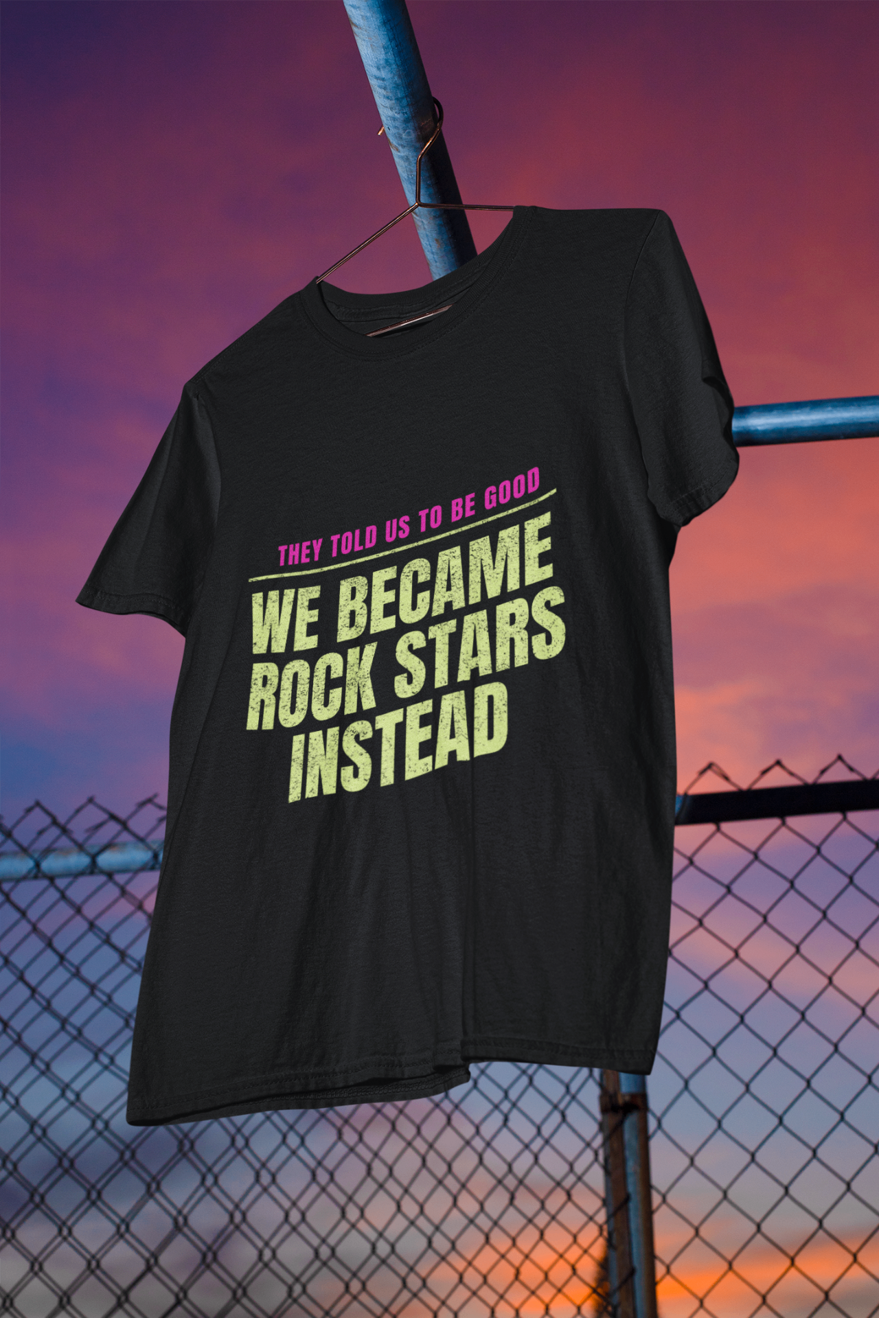 Black t-shirt reading 'They told us to be good — we became rock stars instead'